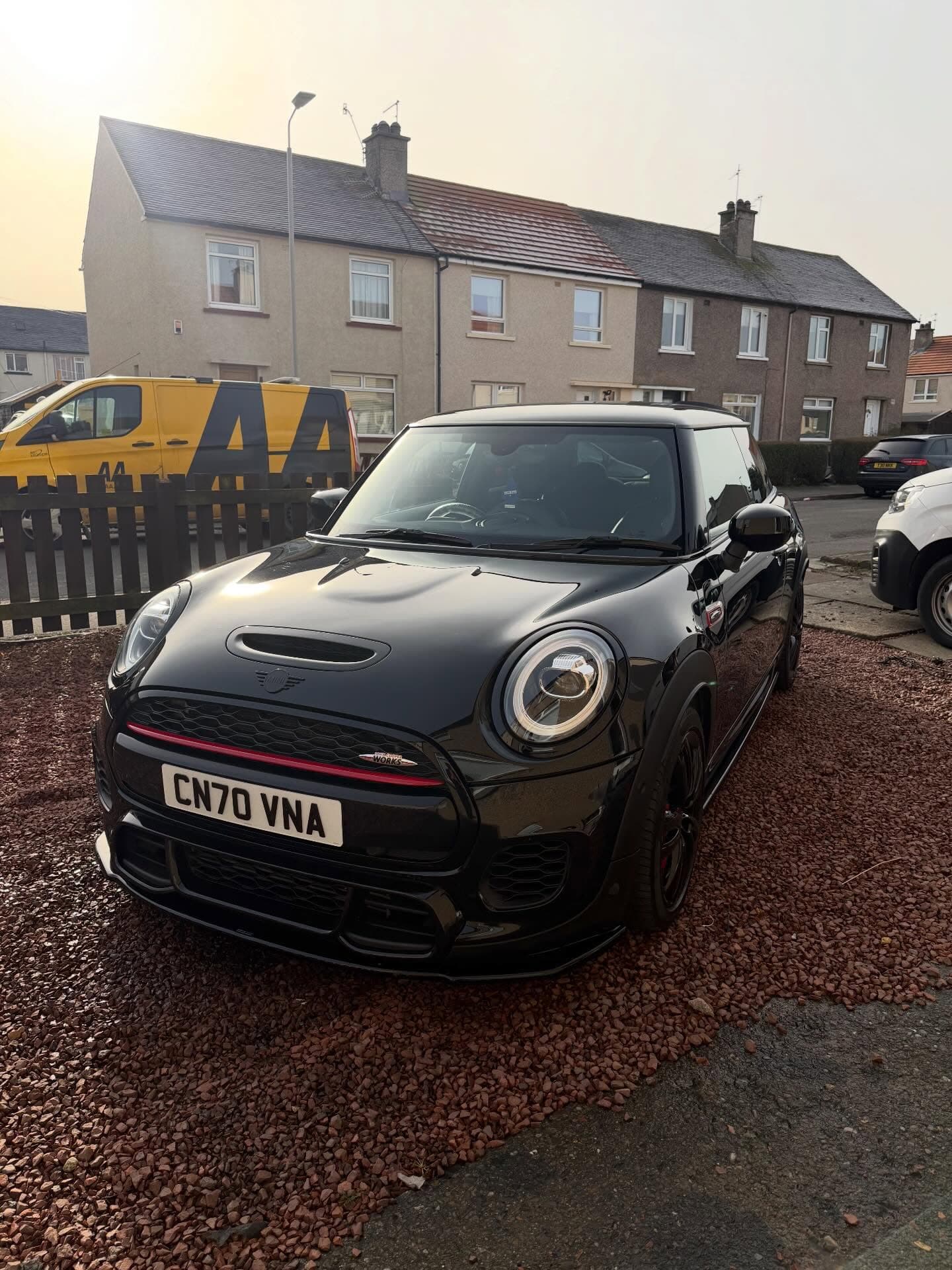 Freshly detailed Mini JCW with a deep gloss finish at golden hour